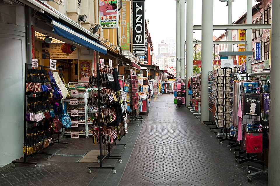 Traditional Chinese shophouse in Southeast Asia with family business signage and merchandise displayed