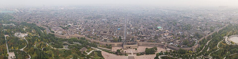 Aerial panoramic view of the walled city of Pingyao in Shanxi province showing dense traditional architecture within ancient walls