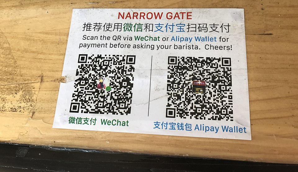 Payment sign showing QR codes for WeChat Pay and Alipay Wallet with bilingual Chinese and English instructions