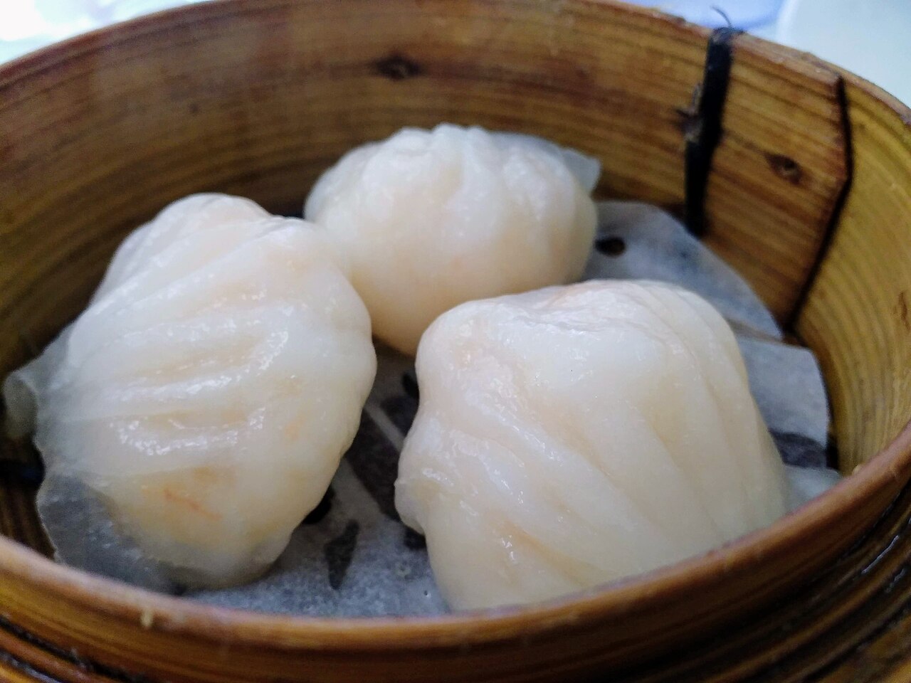 Har gow shrimp dumplings in a bamboo steamer