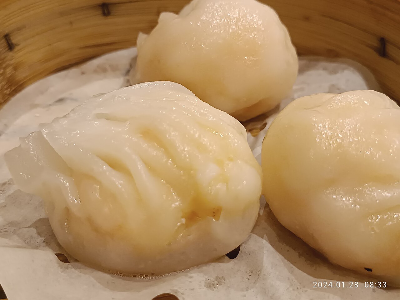 Translucent har gow shrimp dumplings in a bamboo steamer