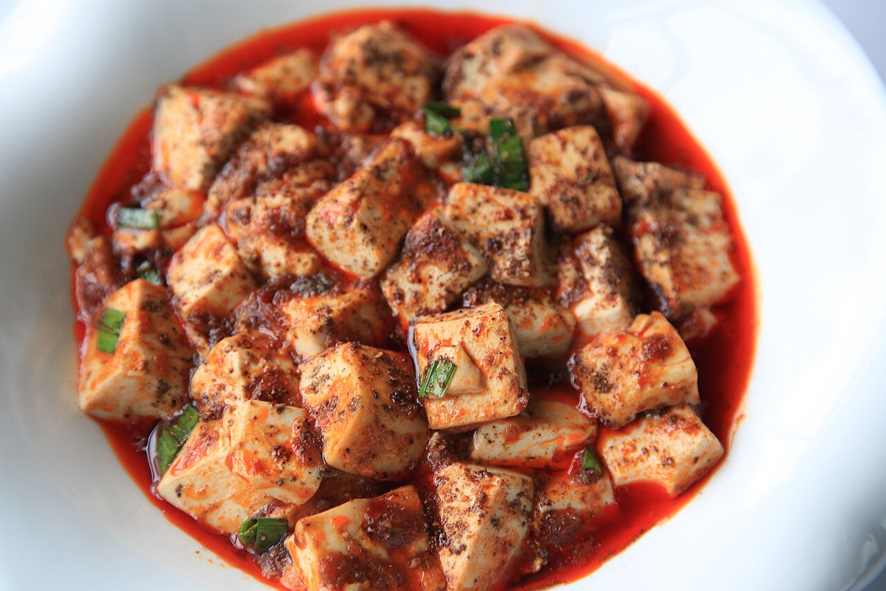 A clay pot of mapo tofu with chili oil and peppercorns