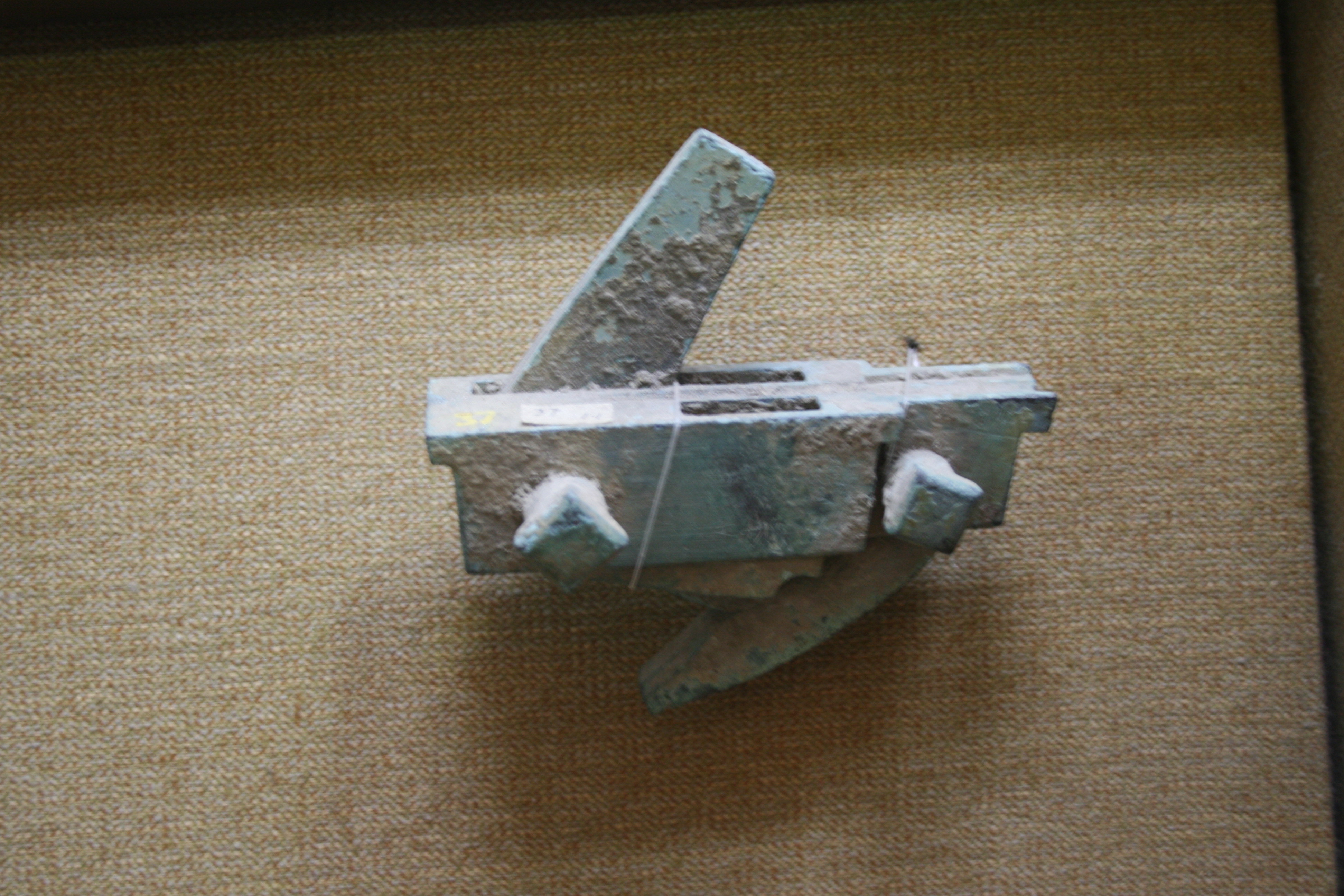 Ancient Chinese bronze crossbow trigger mechanism displayed in a museum
