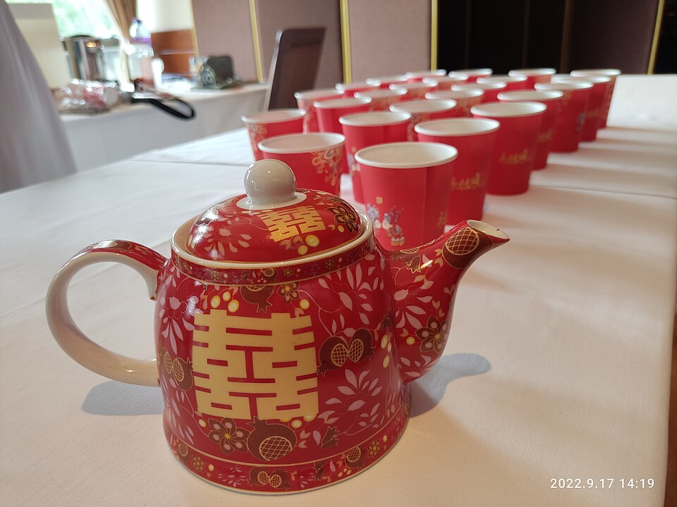 Red double happiness teapot and cups arranged for a Chinese wedding tea ceremony