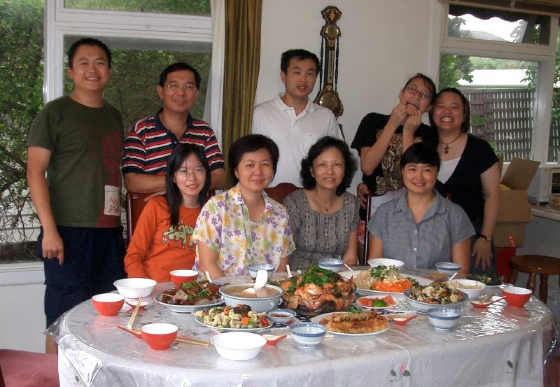 Traditional Chinese New Year reunion dinner with dumplings fish and festive dishes on a round table